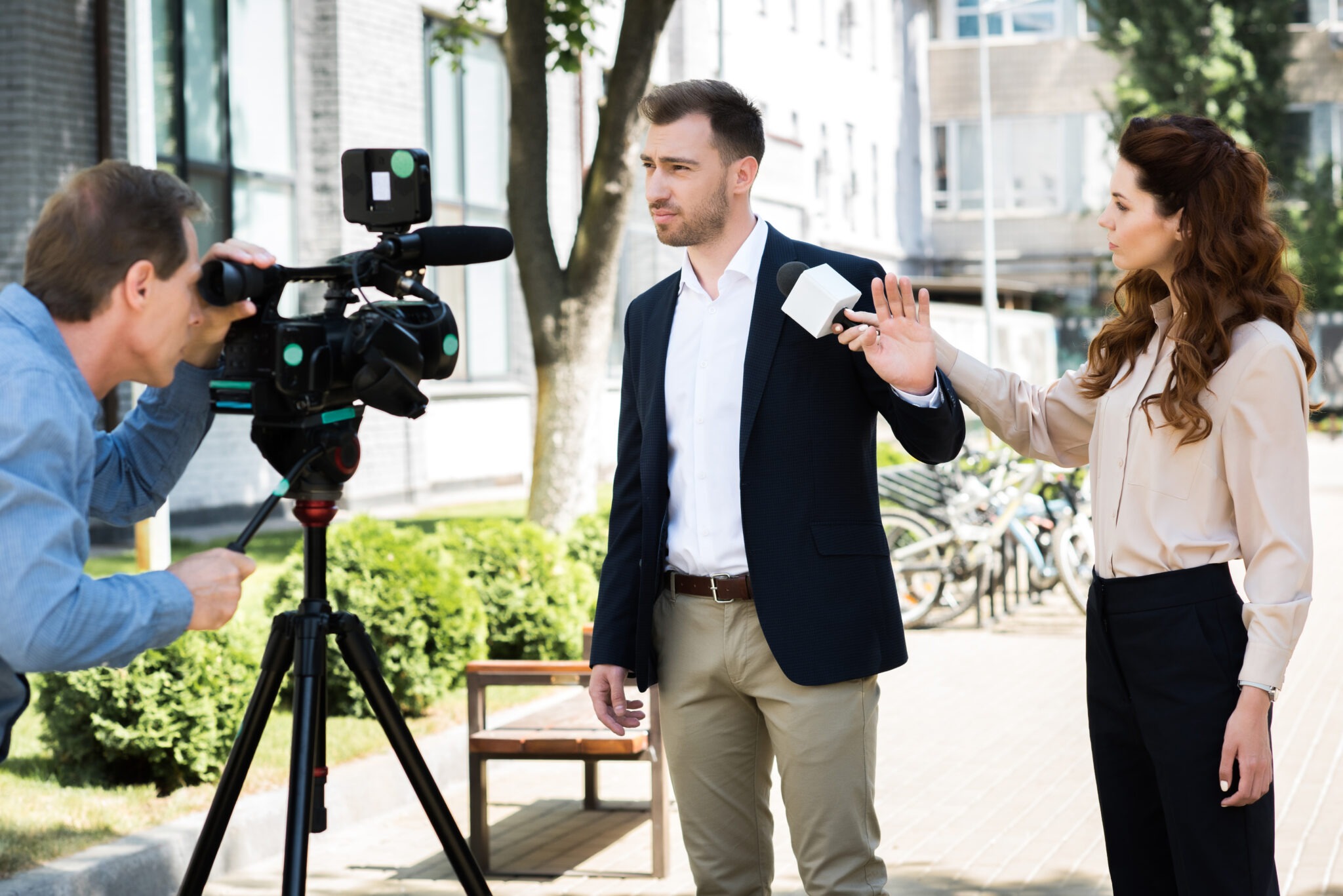 cameraman and professional news reporter with businessman refusing interview
